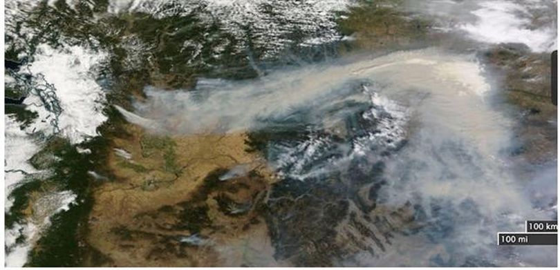 Spokane is in the center of this satellite image wildfire smoke across Pacific Northwest on Aug. 20, 2015.  Origin point of smoke on the left is the 42,000-acre Wolverine Fire in the Glacier Peak Wilderness area near upper Lake Chelan.  Farther east, the 134,000-acre Chelan, 162,000-acre Okanogan, 110,000-acre Colville Indian Reservation, and 90,000-acre Colville area fires all merge and drift east across Montana and into the Midwest. (NOAA)