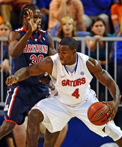 Patric Young of No. 12 Florida works against Arizona’s Angelo Chol on his way toward a career-high 25 points Wednesday. (Associated Press)