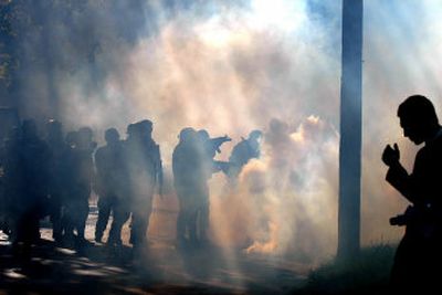 
Police use tear gas against protesters Saturday in Toledo, Ohio, after a crowd that gathered to protest a white supremacist march became violent. The march was canceled because of the rioting.
 (Associated Press / The Spokesman-Review)
