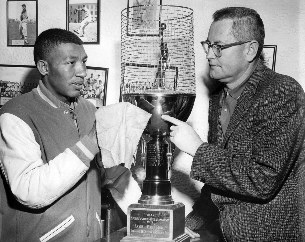 Gonzaga University basketball star, Frank Burgess, and his coach, Hank Anderson, admire the Cage Bowl trophy after the 13th annual game December 7, 1960.  Gonzaga beat Eastern Washington College 87-77 at the Coliseum in front of more than 3,500 fans. Burgess was the NCAA Division I scoring leader in 1960-61. (Photo Archive)