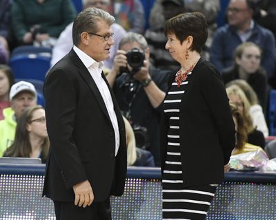 In this Dec. 3, 2017, photo, Connecticut head coach Geno Auriemma, left, talks with Notre Dame head coach Muffet McGraw before an NCAA game in Hartford, Conn. (Jessica Hill / Associated Press)