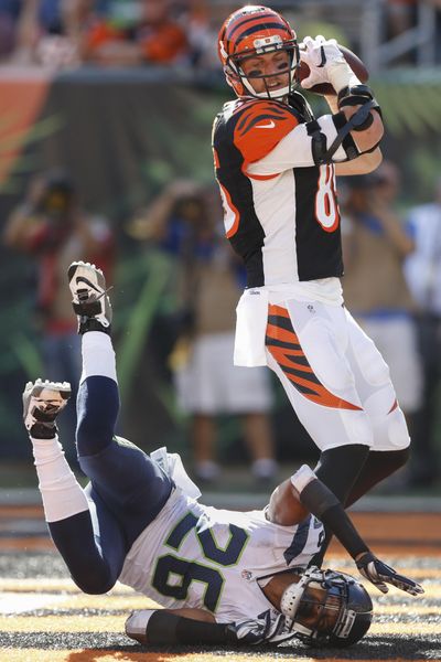 Cincinnati Bengals tight end Tyler Eifert (85) scores a touchdown against Seattle Seahawks cornerback Cary Williams (26) in the second half of an NFL football game, Sunday, Oct. 11, 2015, in Cincinnati. (Gary Landers / Associated Press)