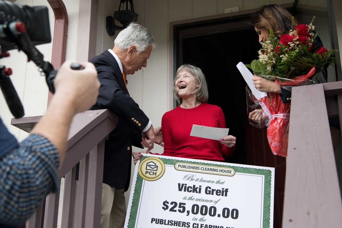 Dave Sayer and Danielle Lam, from the Publishers Clearing House Prize Patrol, present Vicki Greif with a giant check for $25,000 at her home north of Spokane on Thursday, April 12, 2018. (Tyler Tjomsland / The Spokesman-Review)
