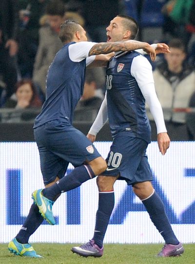 Clint Dempsey, right, celebrates with a teammate after scoring goal in USA’s 1-0 victory over Italy. (Associated Press)