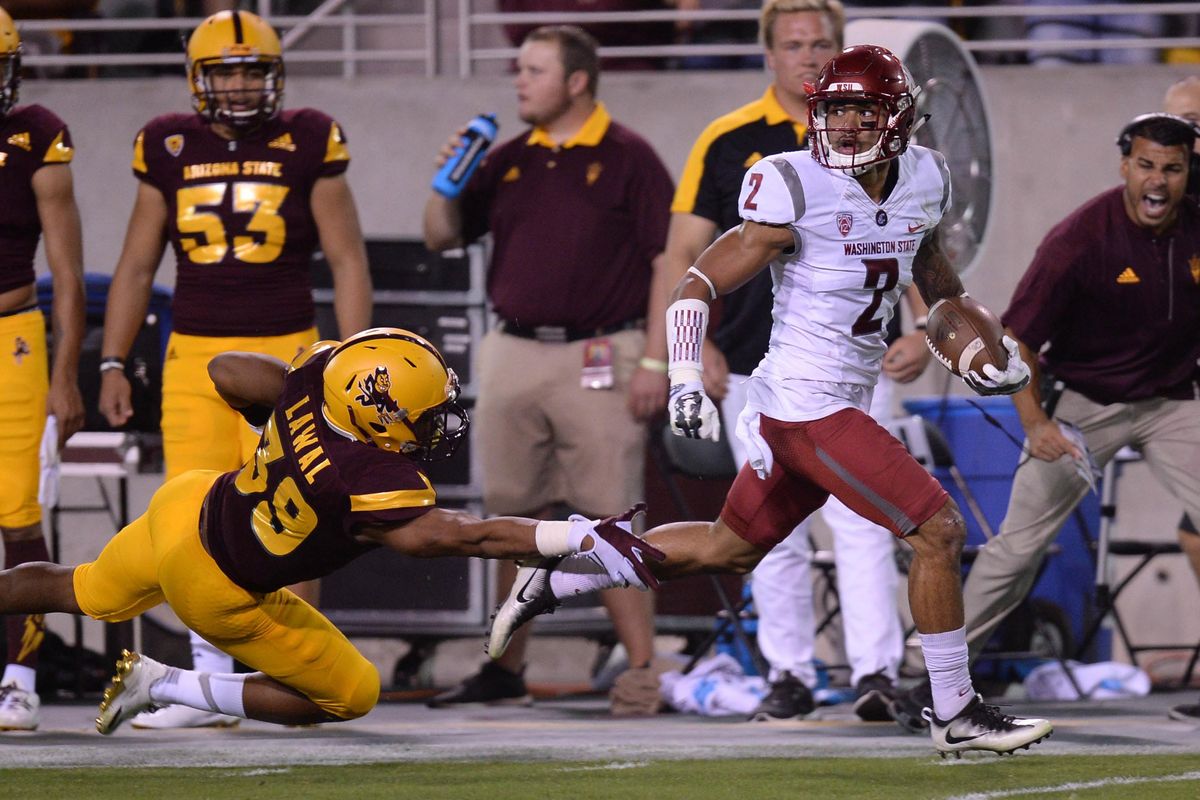 Washington State’s Robert Taylor breaks the tackle of Arizona State linebacker Malik Lawal en route to a 100-yard kickoff return for a touchdown in the second quarter at Pac-12 game at Sun Devil Stadium in Tempe, Arizona. (Joe Camporeale / Associated Press)