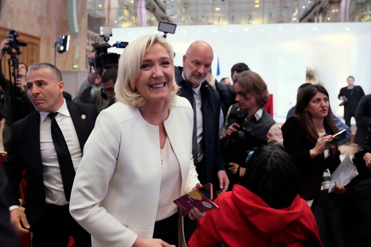 French far-right leader Marine Le Pen leaves after a press conference in Paris, Wednesday, April 13, 2022. Far-right leader Marine Le Pen on Tuesday described France as a nation that would put its people