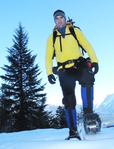 With the Cabinet Mountains in the background, Todd Dunfield of Spokane treks toward the Ross Creek Cedars in northwestern Montana during a snowshoeing trip with the Friends of the Scotchman Peaks Wilderness.  (Rich Landers)
