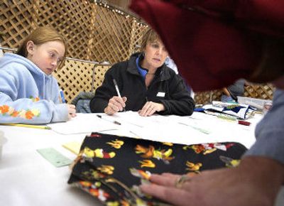 Ashley Drechsel, 10, and her mother, Dana Drechsel, accept entries from Janet Primmer in the crafts competition at the Southeast Spokane County Community Fair in Rockford on Tuesday. The fair starts Friday and runs through the weekend. 
 (Joe Barrentine / The Spokesman-Review)
