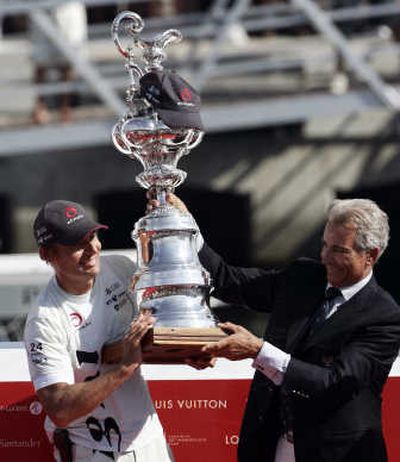 
Alinghi owner Ernesto Bertarelli, left, receives the America's Cup. Associated Press
 (Associated Press / The Spokesman-Review)