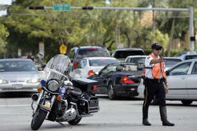 
University of Miami Police Officer Eddie Somarriba directs traffic in Coral Gables, Fla., Tuesday, after power outages affected up to  3 million people across the southern end of the state. Associated Press
 (Associated Press / The Spokesman-Review)