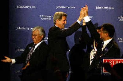 
Democratic presidential candidate Sen. John Kerry, D-Mass., center, high fives Gov. Gary Locke, D-Wash., before speaking at an Asian Pacific Islander American Kerry Victory 2004 reception at the Mayflower Hotel in Washington, Friday. 
 (Associated Press / The Spokesman-Review)