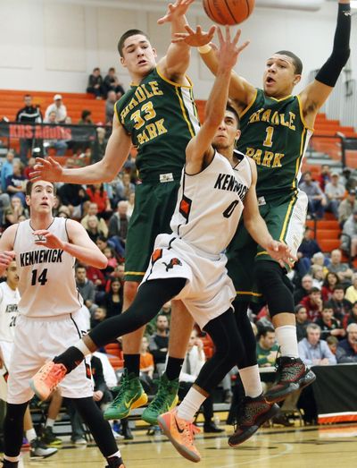 Shadle’s Sam Stratton (33) and Andreas Brown foul Kennewick's Alex Garcia.