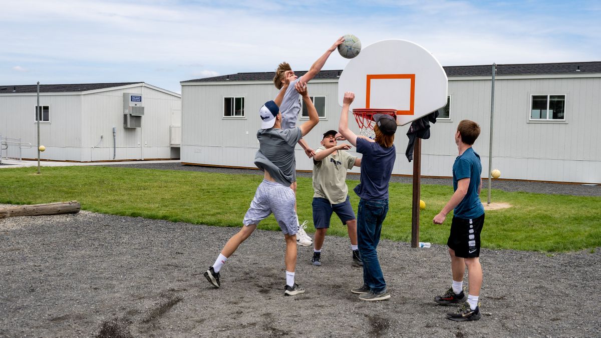 Almira School eighth-graders play some hoops Wednesday on a backboard salvaged from the playground after a fire destroyed their K-8 school building last fall. (COLIN MULVANY/THE SPOKESMAN-REVI)