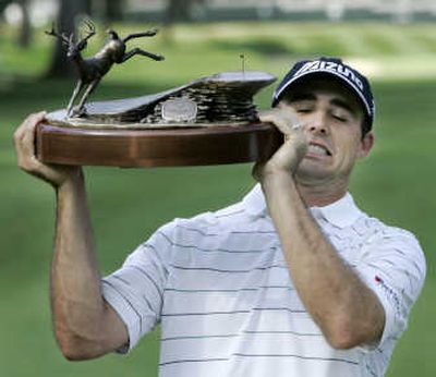 
Golfer Jonathan Byrd lifts the John Deere Classic Trophy over his head on the 18th green Sunday.  Associated Press
 (Associated Press / The Spokesman-Review)