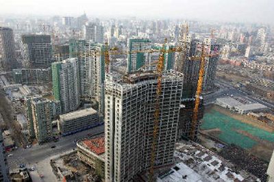 
Construction sites on the Beijing's skyline. China's economy grew by a stunning 9.9 percent in 2005, which brings into sharper focus the need to conserve energy.
 (Associated Press / The Spokesman-Review)