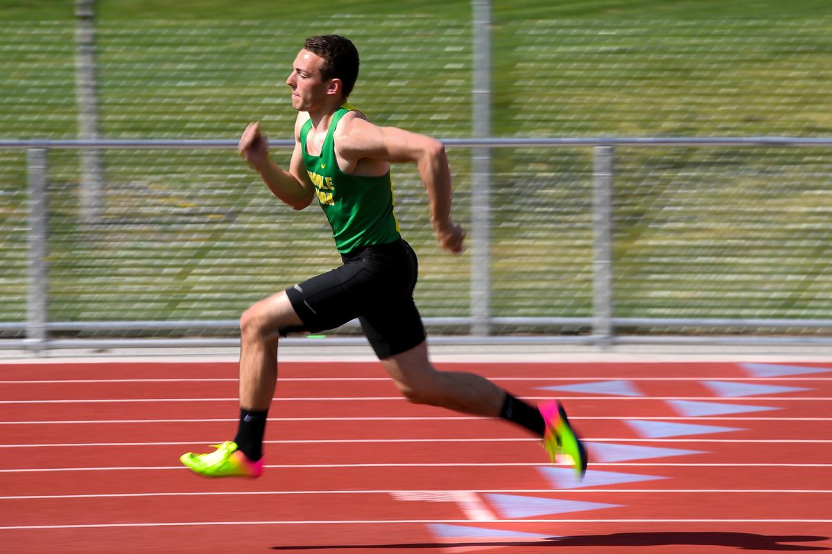 Tony Pizzillo sprints through the curve at the Shadle Park High School track on Wednesday. (Dan Pelle / The Spokesman-Review)
