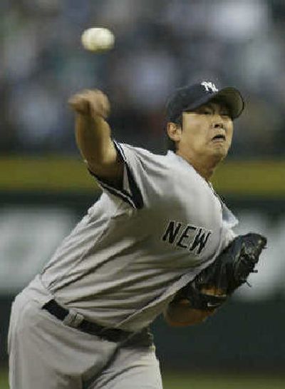 
Yankees starter Chien-Mien Wang pitches against M's Wednesday night en route to his 15th victory. 
 (Associated Press / The Spokesman-Review)