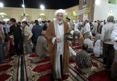 
An Iranian clergyman leaves after prayers at a mosque in Neyshabour, Iran, in Khurasan province, on the eve of the elections. 
 (Associated Press / The Spokesman-Review)