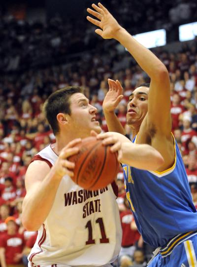 Washington State's Aron Baynes is guarded closely by UCLA's Gordon Drew. UCLA won 61-59.  (Jesse Tinsley / The Spokesman-Review)