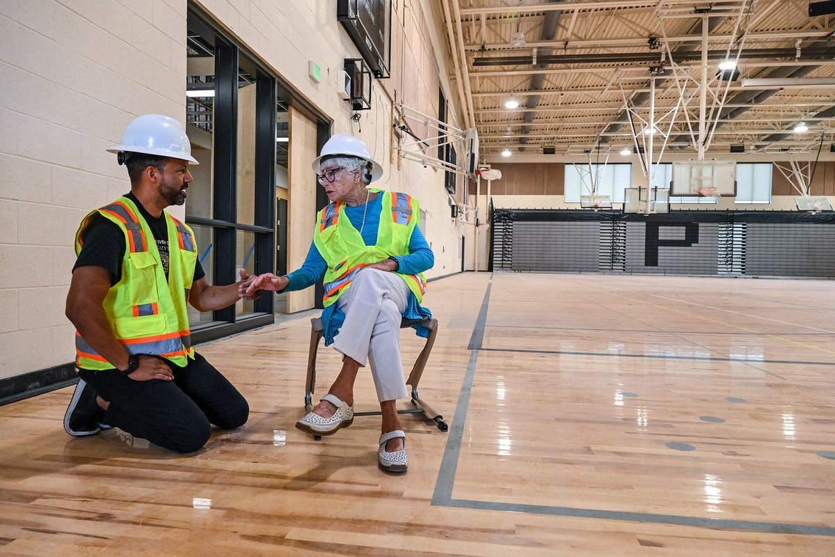 Carla Olman Peperzak Middle School Principal Andre Wicks chats with Carla Peperzak during a tour of the new building, Friday, July 28, 2023, in Spokane.  (DAN PELLE/THE SPOKESMAN-REVIEW)