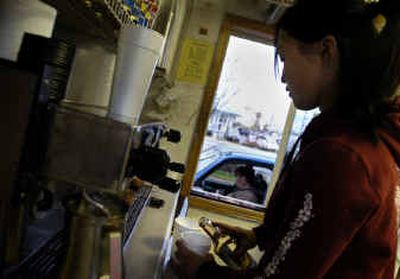 
Barista Liz Kelley makes an espresso drink for a customer at Brewed Awakenings on Friday. The stand has both sewer and water hookups. 
 (Holly Pickett / The Spokesman-Review)