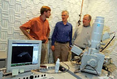 
Researchers gather and talk behind a scanning electron microscope at the Hewlett-Packard Company labs in Palo Alto, Calif., on Monday
 (Associated Press / The Spokesman-Review)