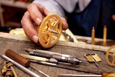 
Leo Tracy assembles workings of a grandfather clock.
 (The Spokesman-Review)