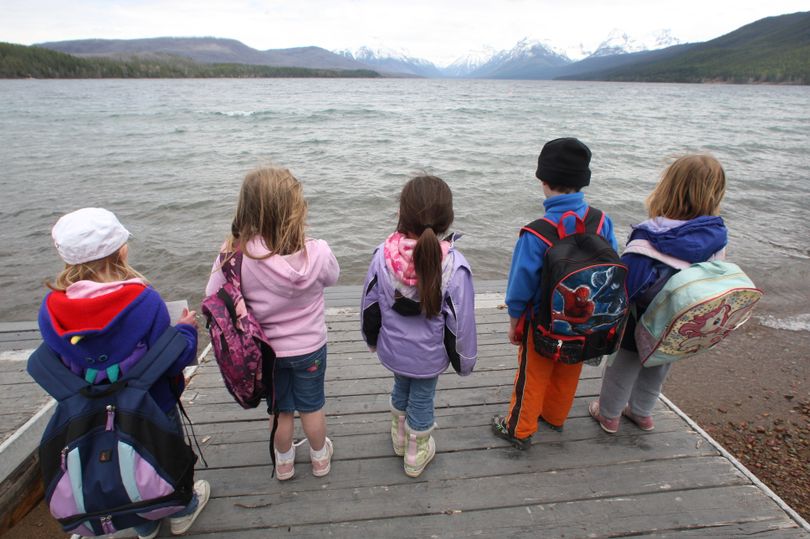 Children stand on a dock at Lake McDonald at Glacier National Park in Montana on Tuesday, May 11, 2010. The million-acre park celebrates it's 100 year anniversary Tuesday. But many of its glaciers have melted, and scientists predict the rest may not last another decade. The forests are drier and disease-ridden, leading to bigger wildfires. Climate change is forcing animals that feed off plants to adapt. (Michael Albans / Fr35247 Ap)