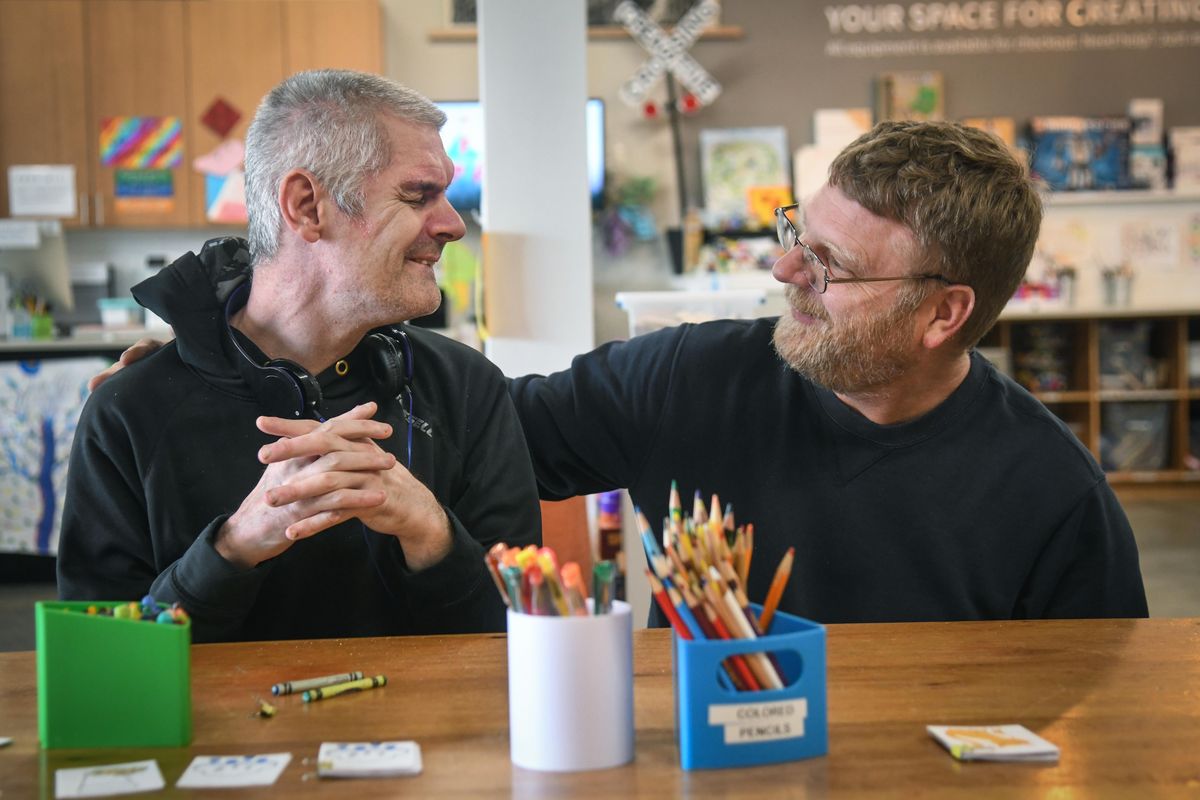 Chris Weppler, right, visits with Greg Beavin during Creative Studio for Variously-abled Adults at Spark Central on Wednesday. (Dan Pelle / The Spokesman-Review)