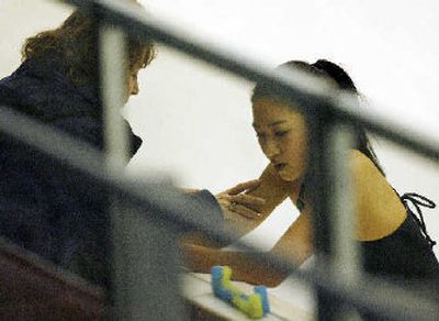 Michelle Kwan speaks to assistant team leader Taffy Holiday during her brief stay at the Turin Winter Olympics.
 (Associated Press / The Spokesman-Review)