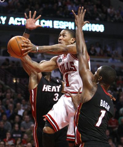 Derrick Rose, center, scored 26 to lead Chicago to a victory over Miami, bringing the Bulls to 2 1/2 games back of Heat in the East. (Associated Press)