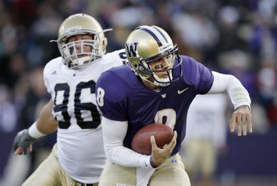 Huskies quarterback Ronnie Fouch has learned on the run.  (Associated Press / The Spokesman-Review)
