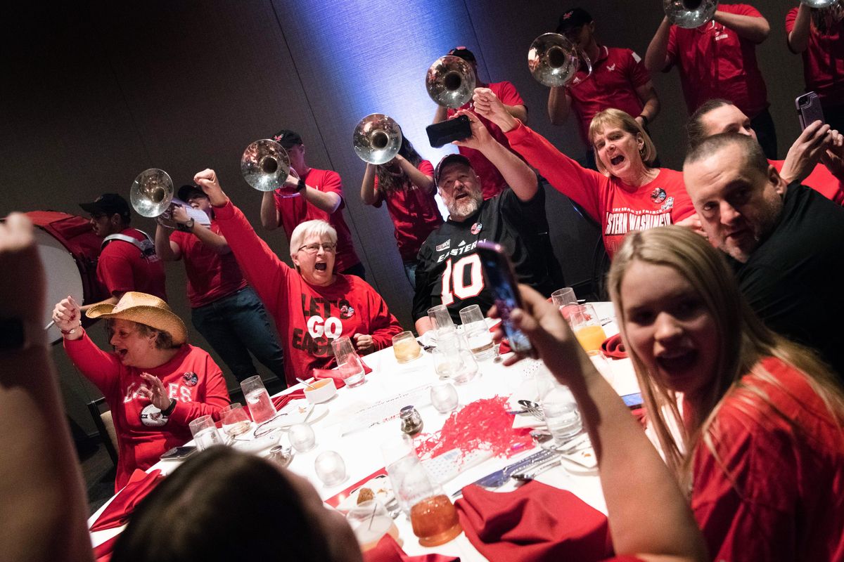 EWU fan, Becky Reilly, second from right, reacts with other long-time Eastern fans as the EWU band plays during an EWU Alumni & Fan Celebration Dinner on Friday, January 4, 2019, at the Renaissance Dallas at Plano Legacy West Hotel in Frisco, TX. (Tyler Tjomsland / The Spokesman-Review)