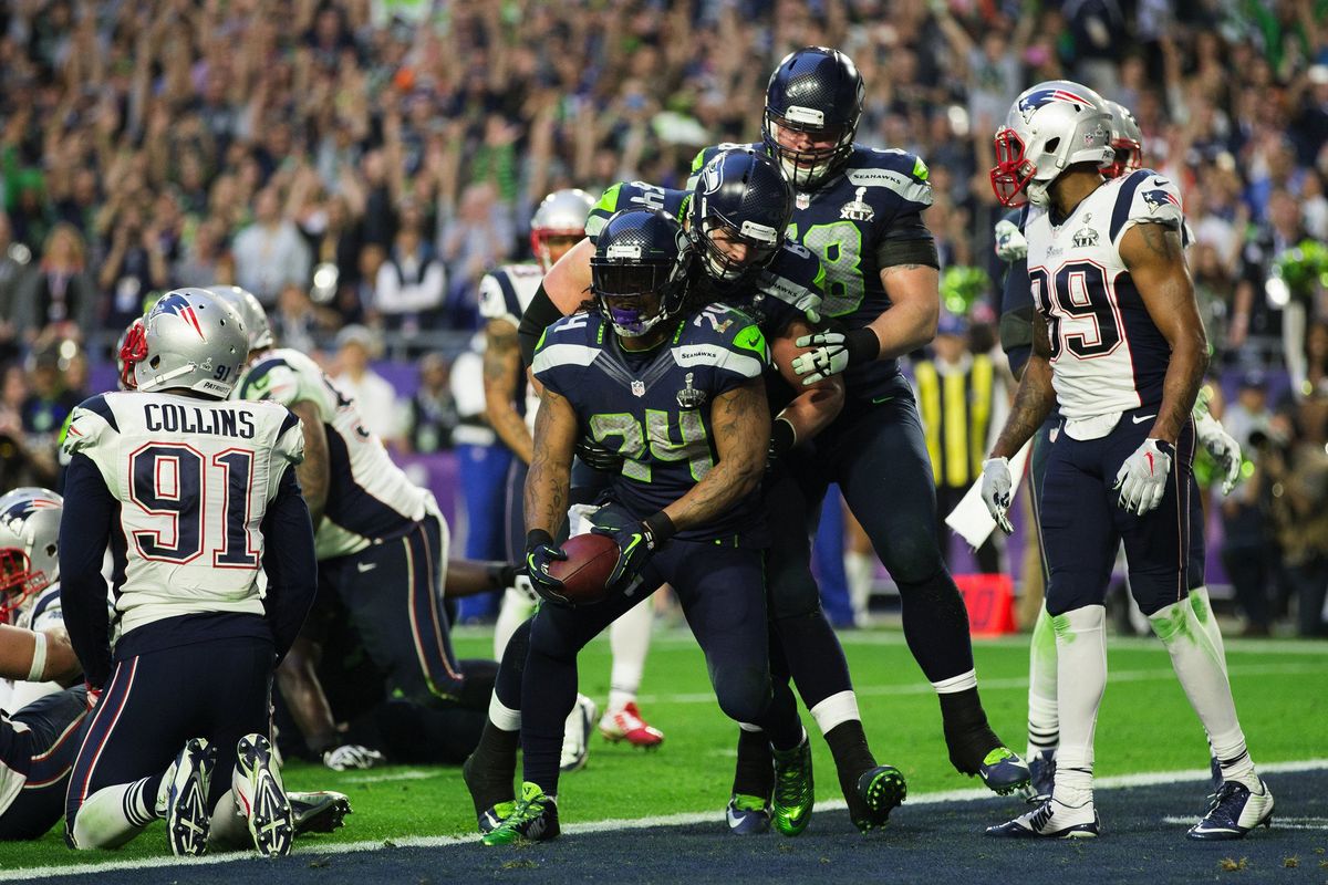 Teammates congratulate Seahawks running back Marshawn Lynch after his 3-yard touchdown run against New England in Super Bowl XLIX on Feb. 1, 2015, in Glendale, Arizona. (Dean Rutz/Seattle Times)