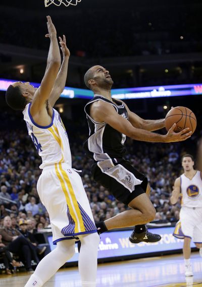 Tony Parker, right, scored 28 points in Spurs’ victory over Warriors. (Associated Press)