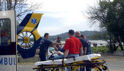 Medstar personnel, Hauser Lake volunteer firefighters and Northern Lakes Fire District perform CPR on one of two brothers who became stranded during a swim.
(The Spokesman-Review)