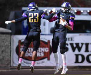 Rogers' Khalil Winfrey, right, celebrates his first touchdown against North Central with teammate Marcus Phillips, left, Friday, Oct. 30, 2015, at Joe Albi Stadium. (Jesse Tinsley / The Spokesman-Review)