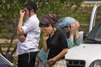 Israelis react in the West Bank Jewish settlement of Bat Ayin on Thursday after an ax-wielding Palestinian went on a rampage, killing a 13-year-old Israeli boy and wounding a 7-year-old.  (Associated Press / The Spokesman-Review)