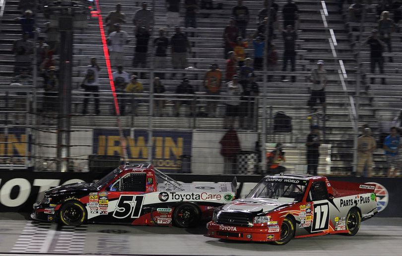 Kyle Busch, driver of the #51 ToyotaCare Toyota, beats Timothy Peters driver of the #17 Parts Plus Toyota to the finish to win the UNOH 200 at Bristol Motor Speedway on August 21, 2013 in Bristol, Tennessee. (Photo by John Harrelson/NASCAR via Getty Images) (John Harrelson / Nascar)
