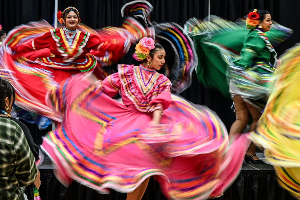 Members of Folklorico de Spokane swirl about the stage while performing recently at the 30th Annual Hispanic/Latino Graduation Ceremony at Spokane Community College.  (DAN PELLE/FOR THESPOKESMN-REVIEW)