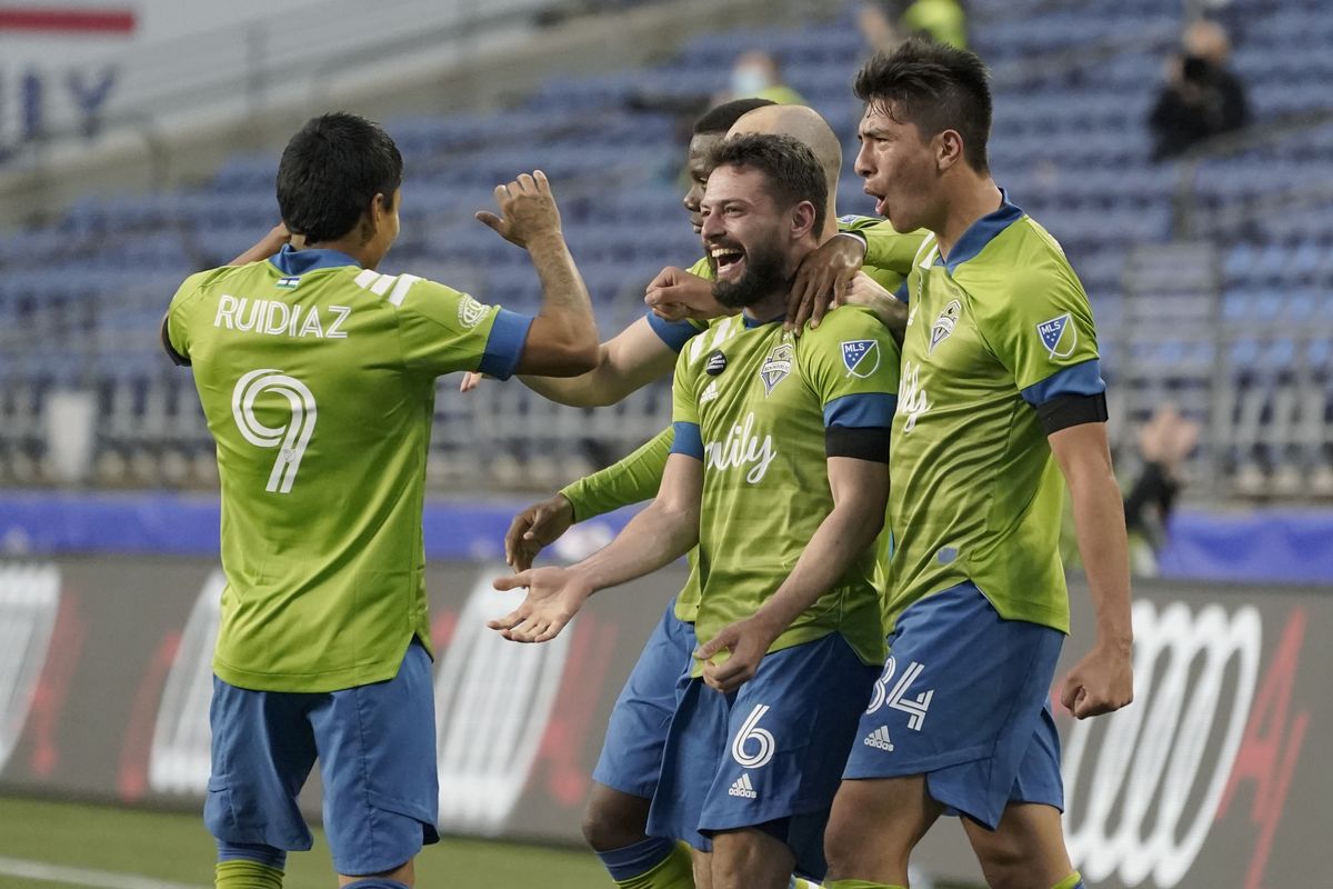 Seattle Sounders midfielder João Paulo celebrates with forward Raul Ruidiaz and midfielder Josh Atencio, right, after João Paulo broke a scoreless tie early in the second half of Friday night’s 4-0 MLS victory against Minnesota United FC at Lumen FIeld in Seattle.  (Associated Press)