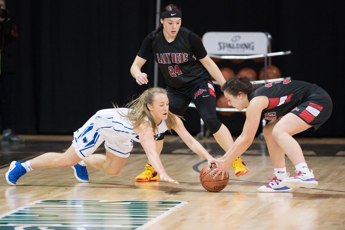 Josie Schultheis (13) of Colton dives for a ground ball against Ruth Moss (32) of Neah Bay during the semifinal of the state 1B tournament on Saturday, March 1, 2019 at the Spokane Arena. The Colton Wildcats beat the Neah Bay Red Devils 83-38. (Libby Kamrowski / The Spokesman-Review)