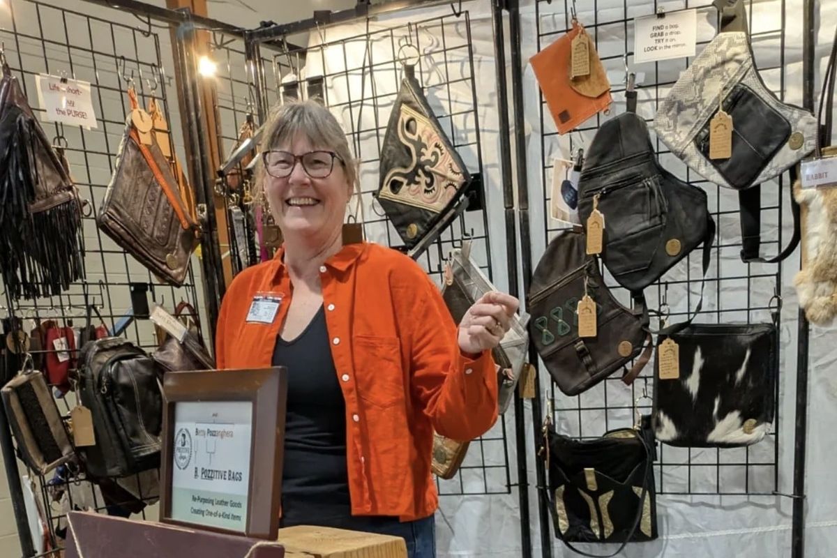 Betsy Pozzanghera with her repurposed leather handbags last March at the Custer’s Spring Arts and Crafts Show in Spokane.  (Courtesy of Barbara J. Wilson)