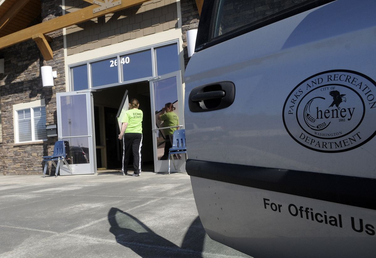 Kim Best of Cheney  Parks and Recreation carries office equipment into new temporary offices in the Tomlinson Black building at 2640 First St. on Monday. (Christopher Anderson / The Spokesman-Review)