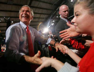 
President Bush shakes hands with supporters during a campaign rally Wednesday in Mason City, Iowa. 
 (Associated Press / The Spokesman-Review)