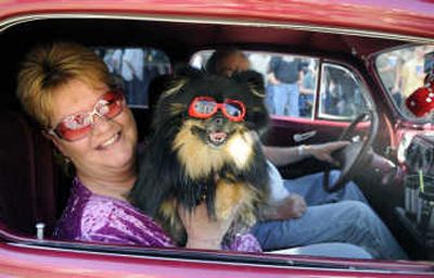 
Bonnie and Mark Potter, of Twin Lakes, Idaho, cruise down Sherman Avenue with their dog Sadie.
 (The Spokesman-Review)