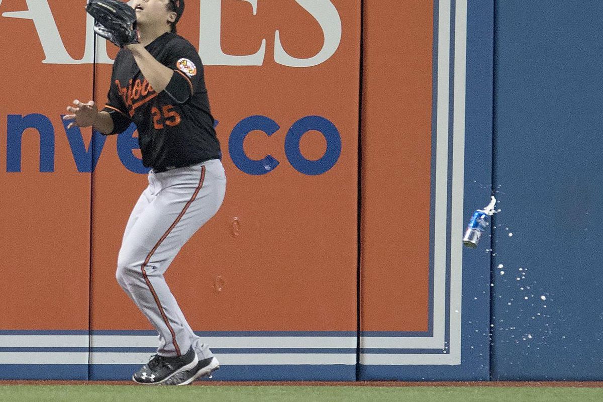 Baltimore Orioles’ Hyun Soo Kim gets under a fly ball as a can falls past him during the seventh inning of an American League wild-card baseball game against the Toronto Blue Jays in Toronto, Tuesday, Oct. 4, 2016. (Mark Blinch / Associated Press)