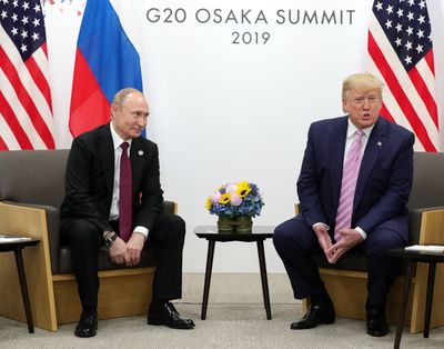 Russian President Vladimir Putin and US President Donald Trump hold a meeting on the sidelines of the G20 summit in Osaka on June 28, 2019. (Mikhail Klimentyev/Sputnik/AFP/Getty Images North America/TNS)