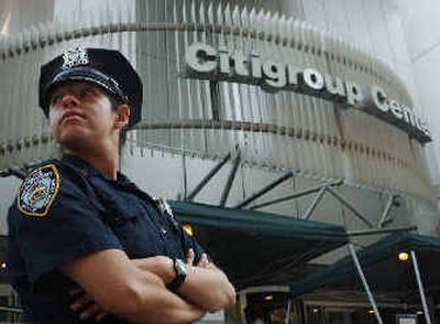 
In a file photo, a New York City police officer stands outside the Citigroup Center, last year, in New York. 
 (Associated Press / The Spokesman-Review)