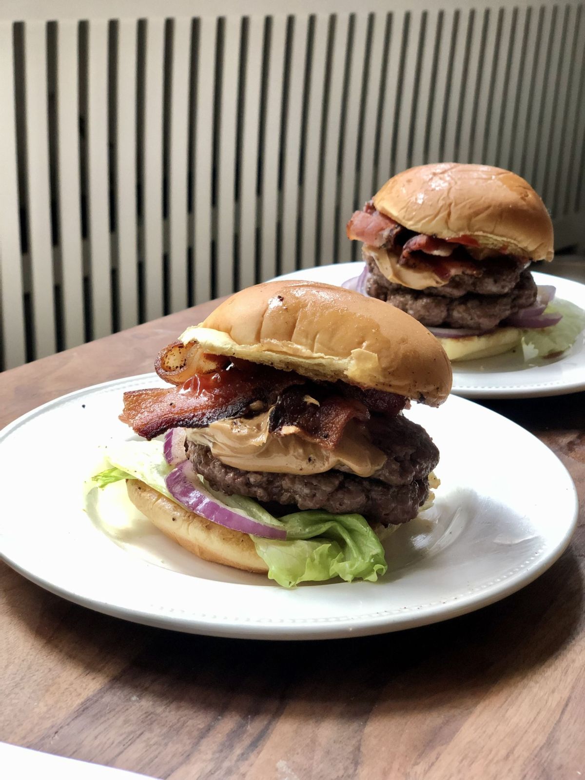 These bacon burgers are elevated with the addition of creamy peanut butter.  (Kate Krader/Bloomberg)